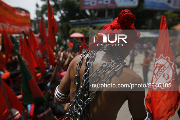 A Bangladeshi worker wears metal chain as he attends a May Day protest rally in Dhaka, Bangladesh on May 01, 2018. Thousands of workers of s...