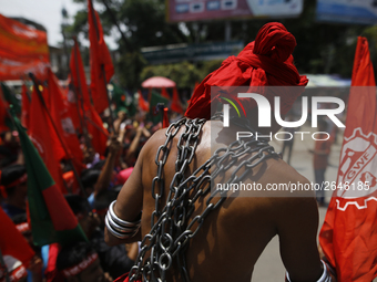 A Bangladeshi worker wears metal chain as he attends a May Day protest rally in Dhaka, Bangladesh on May 01, 2018. Thousands of workers of s...