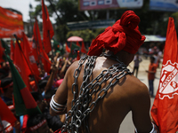 A Bangladeshi worker wears metal chain as he attends a May Day protest rally in Dhaka, Bangladesh on May 01, 2018. Thousands of workers of s...