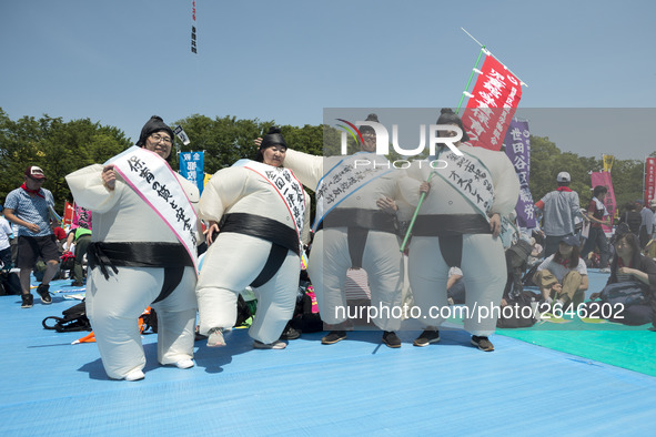 Workers wears a sumo costume during the May Day rally sponsored by the Japanese Trade Union Confederation, known as Rengo at Yoyogi Park in...