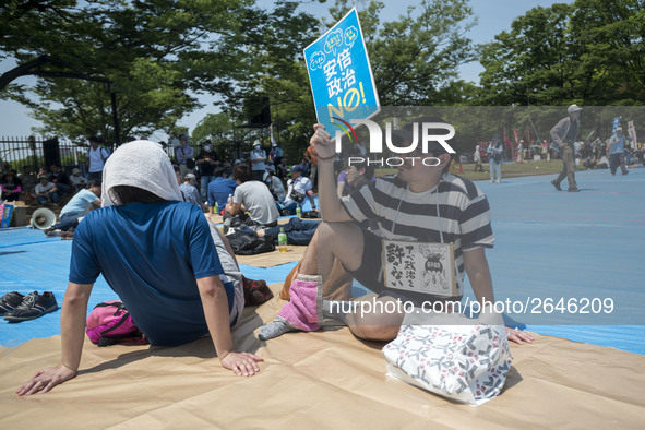 Worker holds placard during the May Day rally sponsored by the Japanese Trade Union Confederation, known as Rengo at Yoyogi Park in Shibuya...