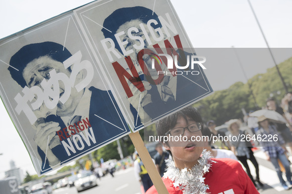 Worker holds placard during the May Day rally sponsored by the Japanese Trade Union Confederation, known as Rengo at Yoyogi Park in Shibuya...