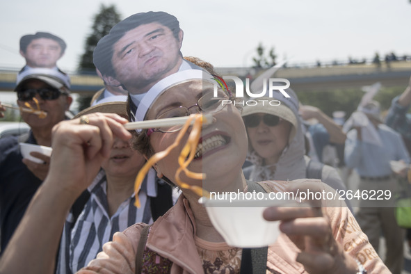 Worker holds placard during the May Day rally sponsored by the Japanese Trade Union Confederation, known as Rengo at Yoyogi Park in Shibuya...