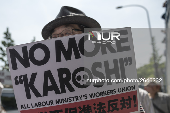 Worker holds placard during the May Day rally sponsored by the Japanese Trade Union Confederation, known as Rengo at Yoyogi Park in Shibuya...