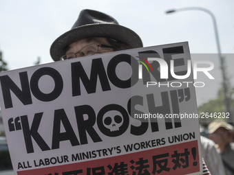 Worker holds placard during the May Day rally sponsored by the Japanese Trade Union Confederation, known as Rengo at Yoyogi Park in Shibuya...