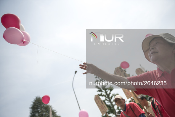 Worker holds pink balloons during the May Day rally sponsored by the Japanese Trade Union Confederation, known as Rengo at Yoyogi Park in Sh...