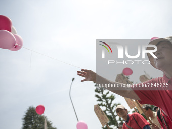 Worker holds pink balloons during the May Day rally sponsored by the Japanese Trade Union Confederation, known as Rengo at Yoyogi Park in Sh...