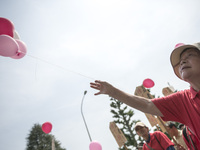 Worker holds pink balloons during the May Day rally sponsored by the Japanese Trade Union Confederation, known as Rengo at Yoyogi Park in Sh...