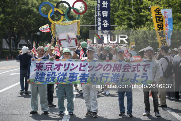 Workers hold placards during the May Day rally sponsored by the Japanese Trade Union Confederation, known as Rengo at Yoyogi Park in Shibuya...