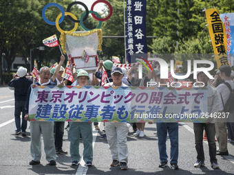 Workers hold placards during the May Day rally sponsored by the Japanese Trade Union Confederation, known as Rengo at Yoyogi Park in Shibuya...