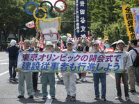 Workers hold placards during the May Day rally sponsored by the Japanese Trade Union Confederation, known as Rengo at Yoyogi Park in Shibuya...