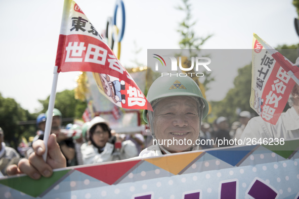 Worker holds placard during the May Day rally sponsored by the Japanese Trade Union Confederation, known as Rengo at Yoyogi Park in Shibuya...