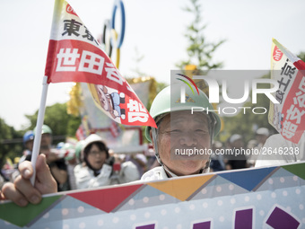 Worker holds placard during the May Day rally sponsored by the Japanese Trade Union Confederation, known as Rengo at Yoyogi Park in Shibuya...