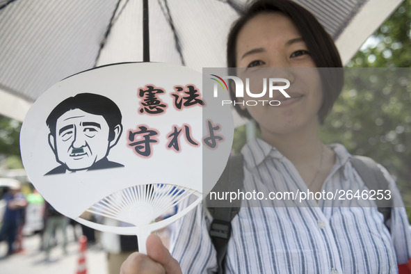 Worker holds placard during the May Day rally sponsored by the Japanese Trade Union Confederation, known as Rengo at Yoyogi Park in Shibuya...