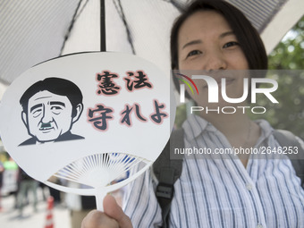 Worker holds placard during the May Day rally sponsored by the Japanese Trade Union Confederation, known as Rengo at Yoyogi Park in Shibuya...