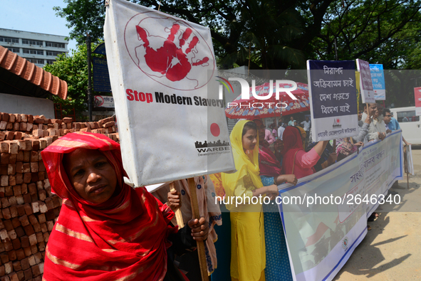 Bangladeshi garment workers and other labor organization members take part in a rally to mark May Day, International Workers' Day in Dhaka,...