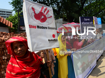 Bangladeshi garment workers and other labor organization members take part in a rally to mark May Day, International Workers' Day in Dhaka,...