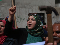 Palestinian labor activists chant slogans during a march for the International Labor Day at the Palestine square in Gaza City, May 1, 2018....