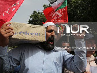 Palestinian labor activists chant slogans during a march for the International Labor Day at the Palestine square in Gaza City, May 1, 2018....