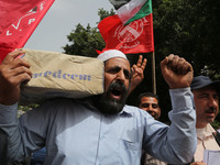 Palestinian labor activists chant slogans during a march for the International Labor Day at the Palestine square in Gaza City, May 1, 2018....