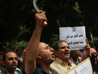 Palestinian labor activists chant slogans during a march for the International Labor Day at the Palestine square in Gaza City, May 1, 2018....