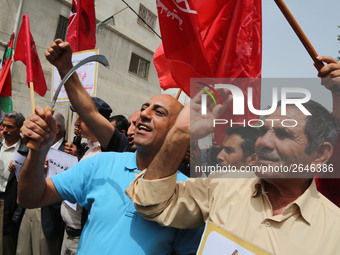 Palestinian labor activists chant slogans during a march for the International Labor Day at the Palestine square in Gaza City, May 1, 2018....