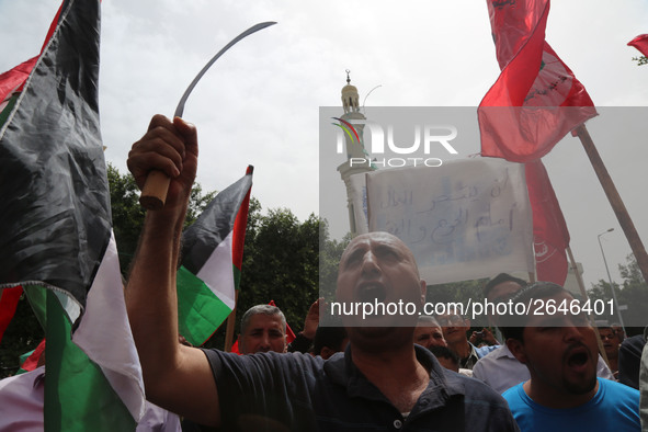 Palestinian labor activists chant slogans during a march for the International Labor Day at the Palestine square in Gaza City, May 1, 2018....