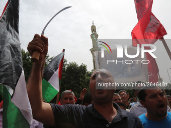 Palestinian labor activists chant slogans during a march for the International Labor Day at the Palestine square in Gaza City, May 1, 2018....