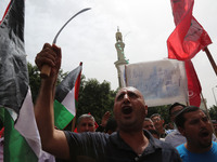 Palestinian labor activists chant slogans during a march for the International Labor Day at the Palestine square in Gaza City, May 1, 2018....