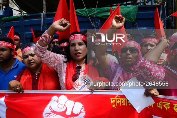 Bangladeshi garment workers and other labor organization members take part in a rally to mark May Day, International Workers' Day in Dhaka,...