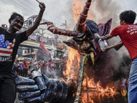 Workers burn an effigy of President Rodrigo Duterte as they take part in labor day demonstrations outside the presidential palace in Manila,...