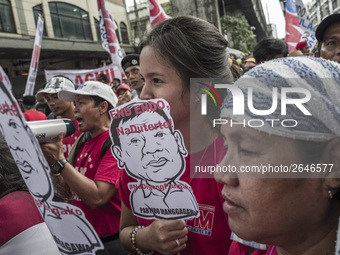 Workers hold placards with President Rodrigo Duterte's portrait during labor day demonstrations outside the presidential palace in Manila, P...