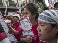 Workers hold placards with President Rodrigo Duterte's portrait during labor day demonstrations outside the presidential palace in Manila, P...