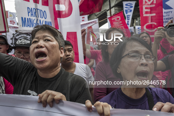 Workers shout slogans during labor day demonstrations outside the presidential palace in Manila, Philippines, May 1, 2018. Thousands of work...