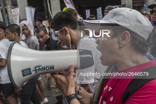 A workers shouts slogans over a speakerphone during labor day demonstrations outside the presidential palace in Manila, Philippines, May 1,...