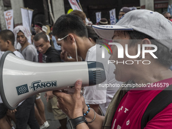 A workers shouts slogans over a speakerphone during labor day demonstrations outside the presidential palace in Manila, Philippines, May 1,...