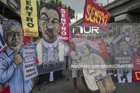 Placards depicting different labor government officials are seen during demonstrations outside the presidential palace in Manila, Philippine...