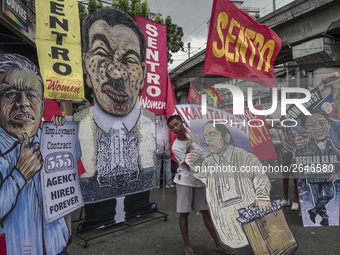 Placards depicting different labor government officials are seen during demonstrations outside the presidential palace in Manila, Philippine...