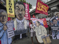 Placards depicting different labor government officials are seen during demonstrations outside the presidential palace in Manila, Philippine...