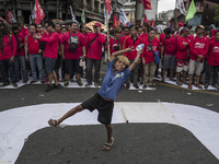 A street child plays while workers take part in labor day demonstrations outside the presidential palace in Manila, Philippines, May 1, 2018...