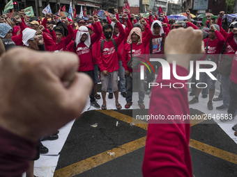 Workers raise their fists during labor day demonstrations outside the presidential palace in Manila, Philippines, May 1, 2018. Thousands of...