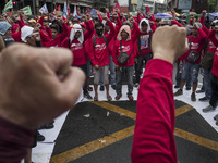 Workers raise their fists during labor day demonstrations outside the presidential palace in Manila, Philippines, May 1, 2018. Thousands of...