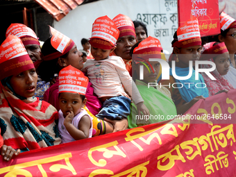 Bangladeshi garment workers and other labor organization members take part in a rally to mark May Day, International Workers' Day in Dhaka,...