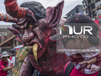 A worker helps move an effigy of President Rodrigo Duterte as he takes part in labor day demonstrations outside the presidential palace in M...