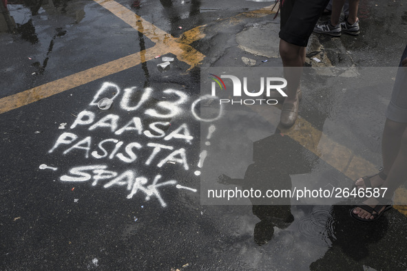 Graffiti calling President Rodrigo Duterte a "fascist" is seen on a road during labor day demonstrations outside the presidential palace in...