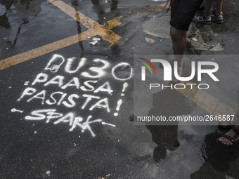 Graffiti calling President Rodrigo Duterte a "fascist" is seen on a road during labor day demonstrations outside the presidential palace in...