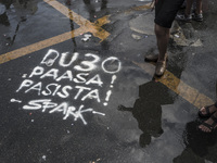 Graffiti calling President Rodrigo Duterte a "fascist" is seen on a road during labor day demonstrations outside the presidential palace in...