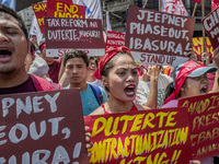 Workers shout slogans during labor day demonstrations outside the presidential palace in Manila, Philippines, May 1, 2018. Thousands of work...