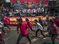 Workers perform as they take part in labor day demonstrations outside the presidential palace in Manila, Philippines, May 1, 2018. Thousands...