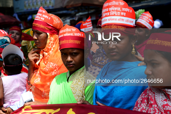 Bangladeshi garment workers and other labor organization members take part in a rally to mark May Day, International Workers' Day in Dhaka,...